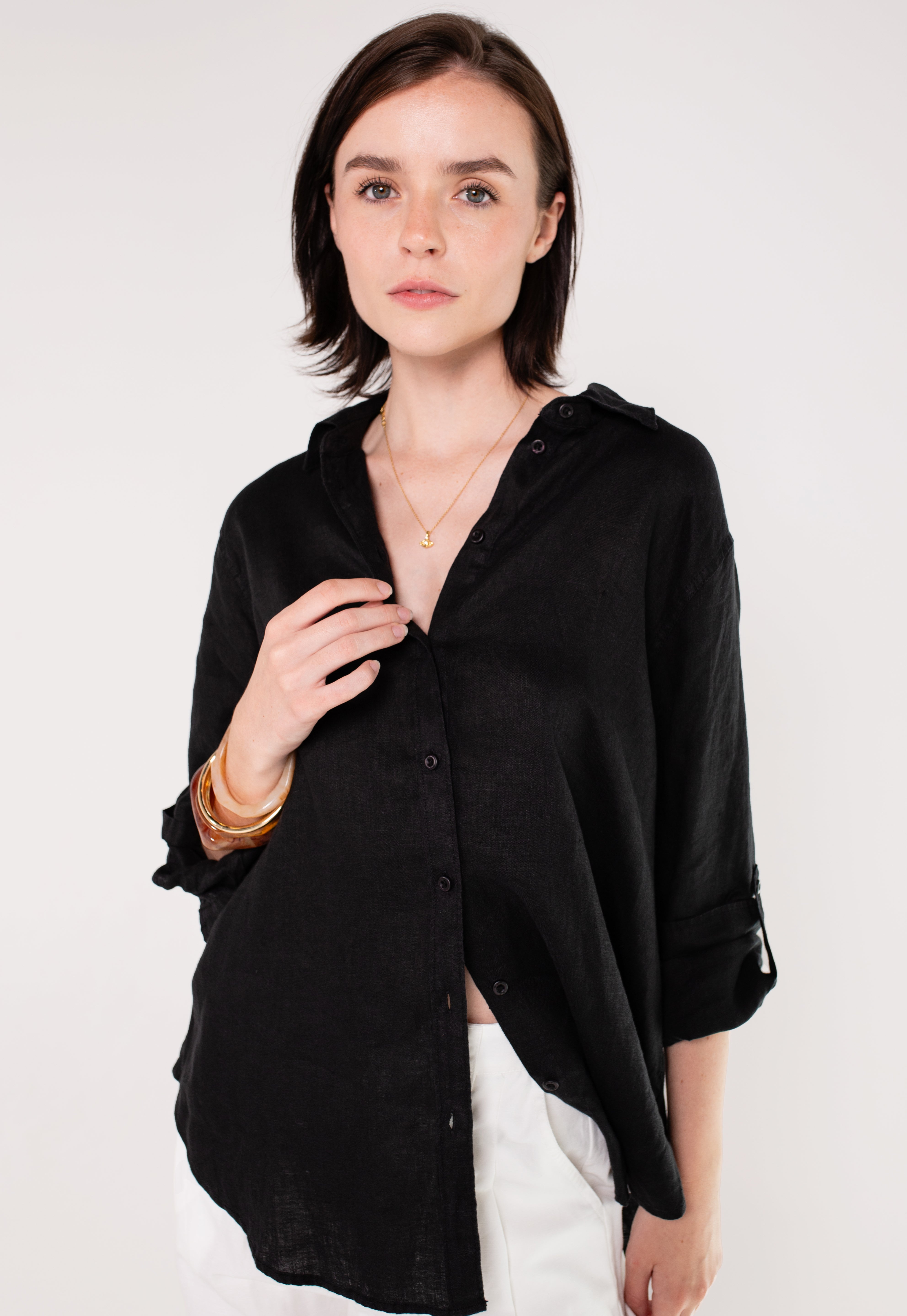 Model wearing Hut Black Embroidered Palm Boyfriend Linen Shirt with no pockets and sleeves rolled up