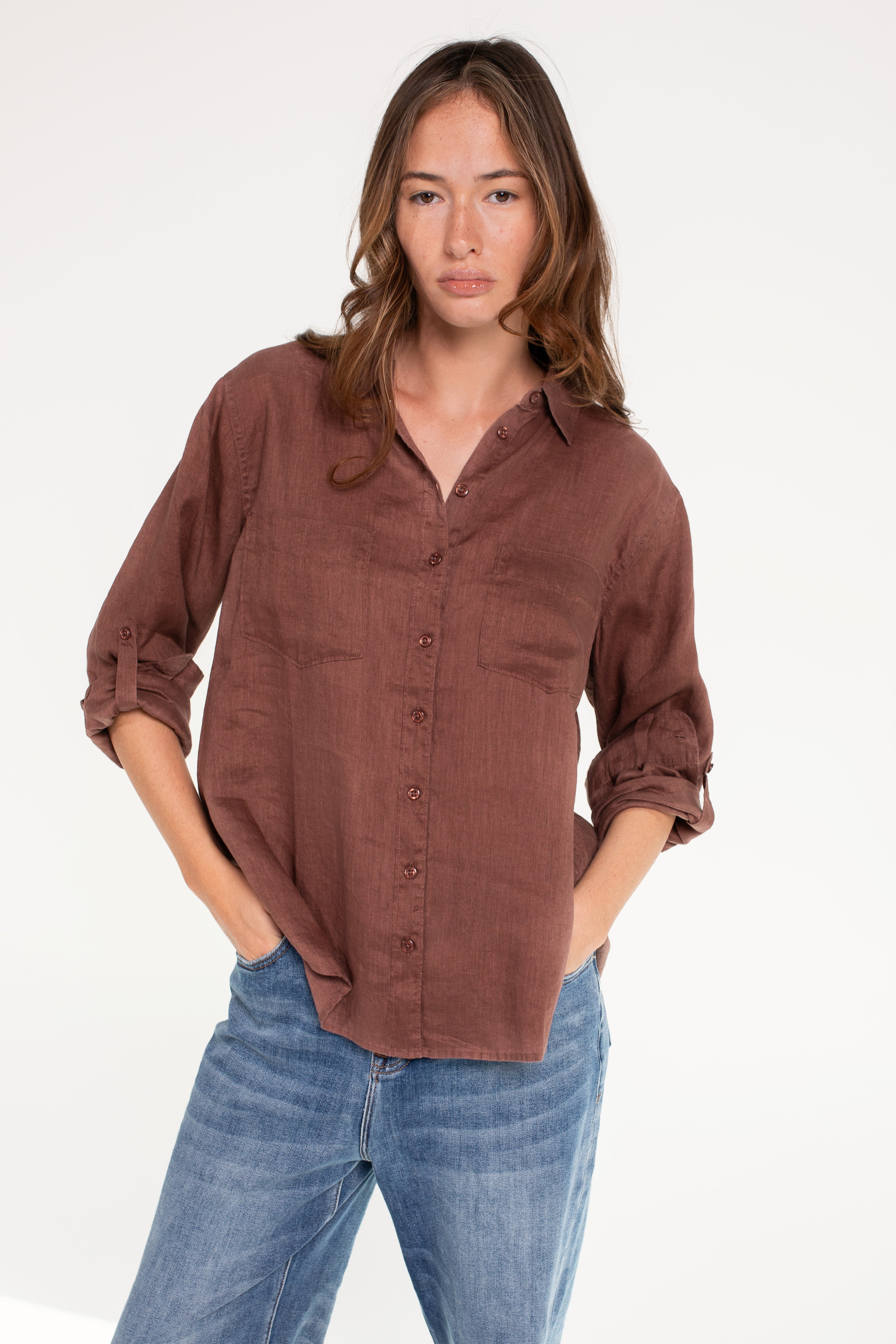 Model wearing Hut Cinnamon Boyfriend Linen Shirt with tab sleeves and two chest pockets.