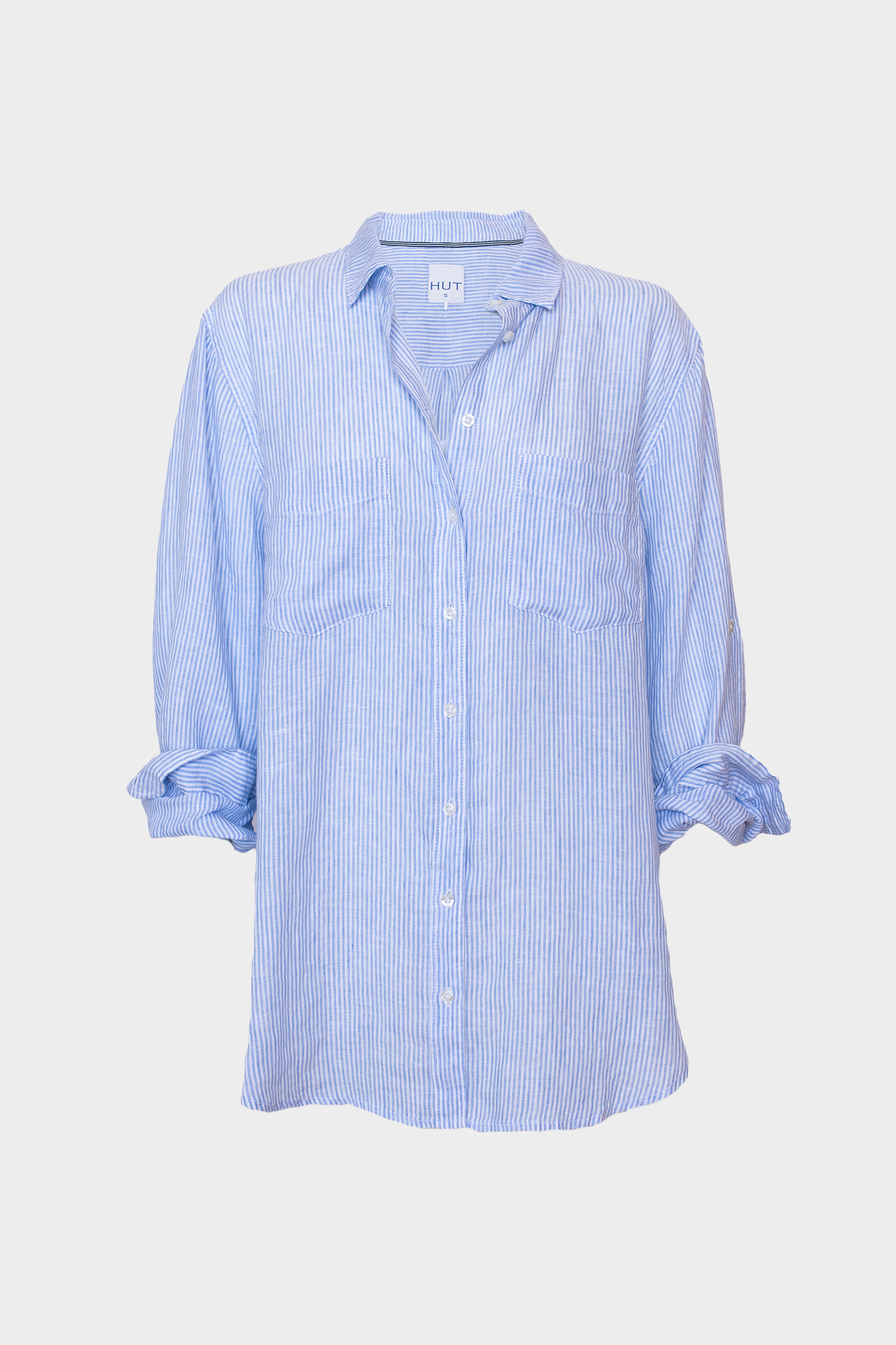 Light blue striped linen boyfriend shirt with two chest pockets and tab sleeves on a white background