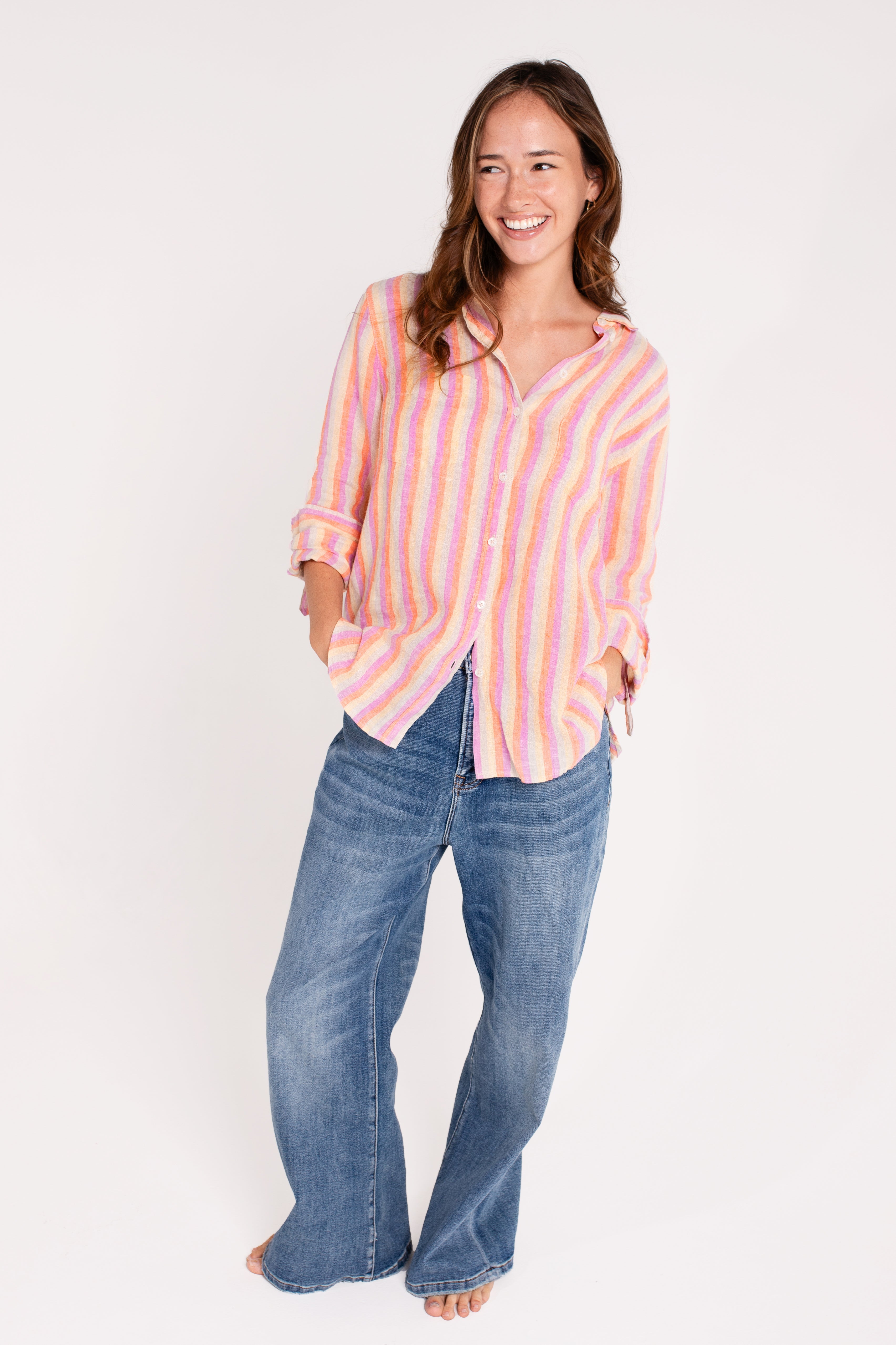 Model wearing Hut clothing groove stripe boyfriend linen shirt and denim jeans against a white background