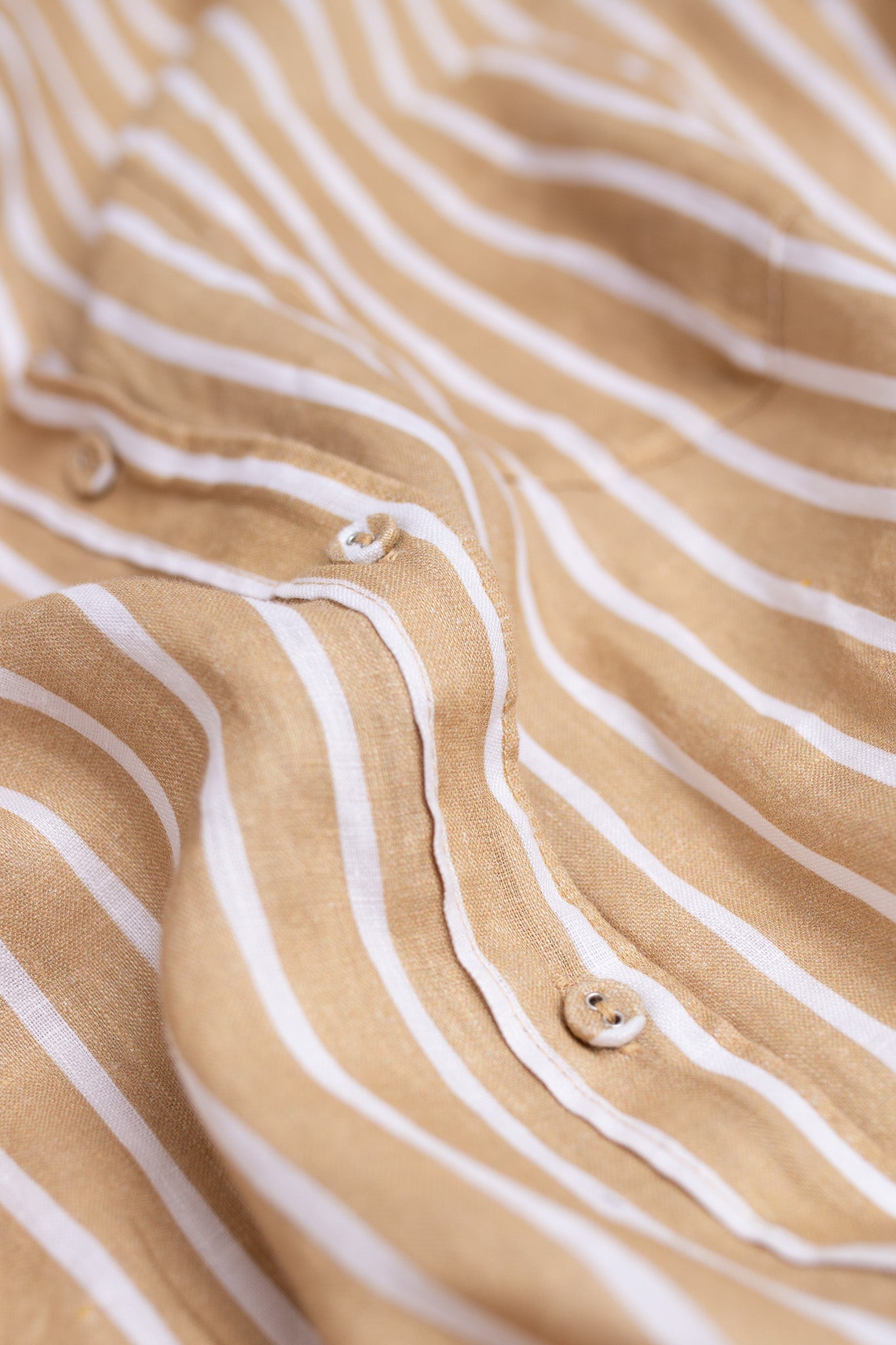 Close up of placket, self covered buttons and fabric