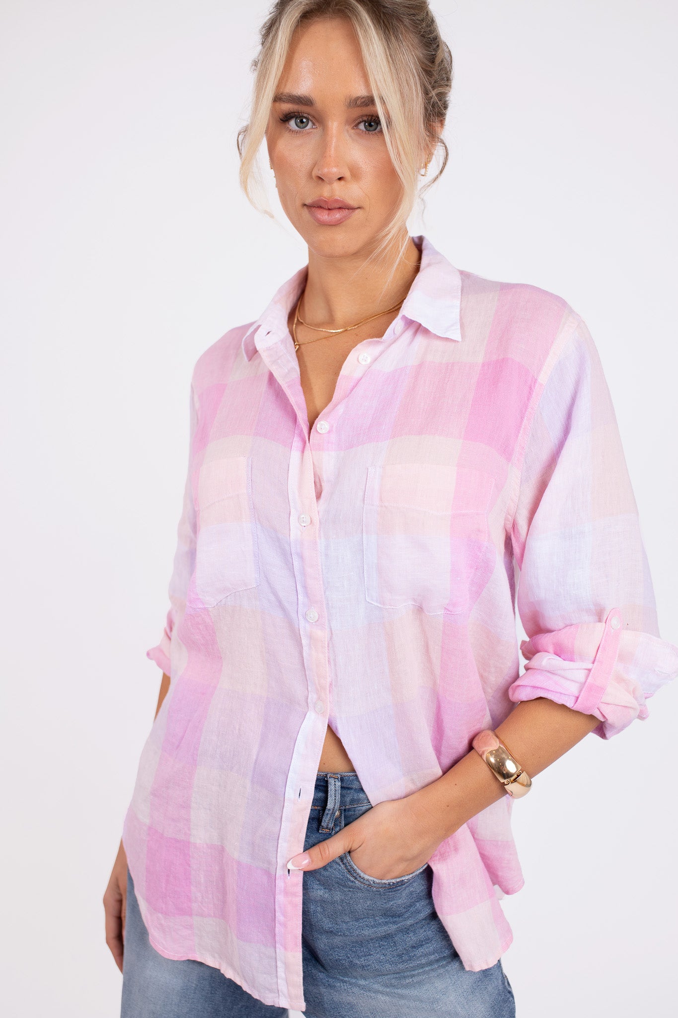 Model wearing a Hut clothing lilac plaid boyfriend linen shirt with two chest pockets and her hand in denim jean pocket