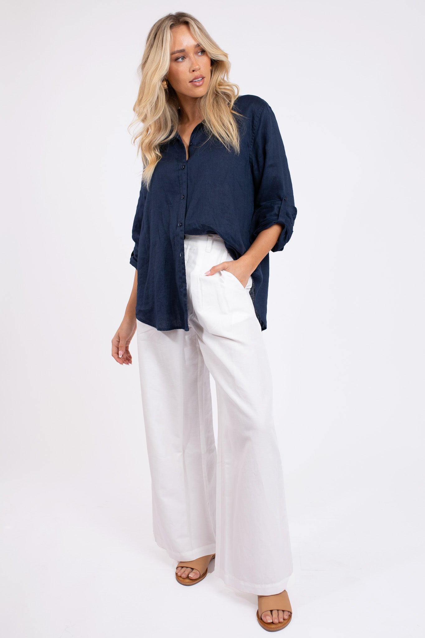 Model wearing Hut Clothing Navy No Pocket Boyfriend Linen Shirt with white wide leg pants