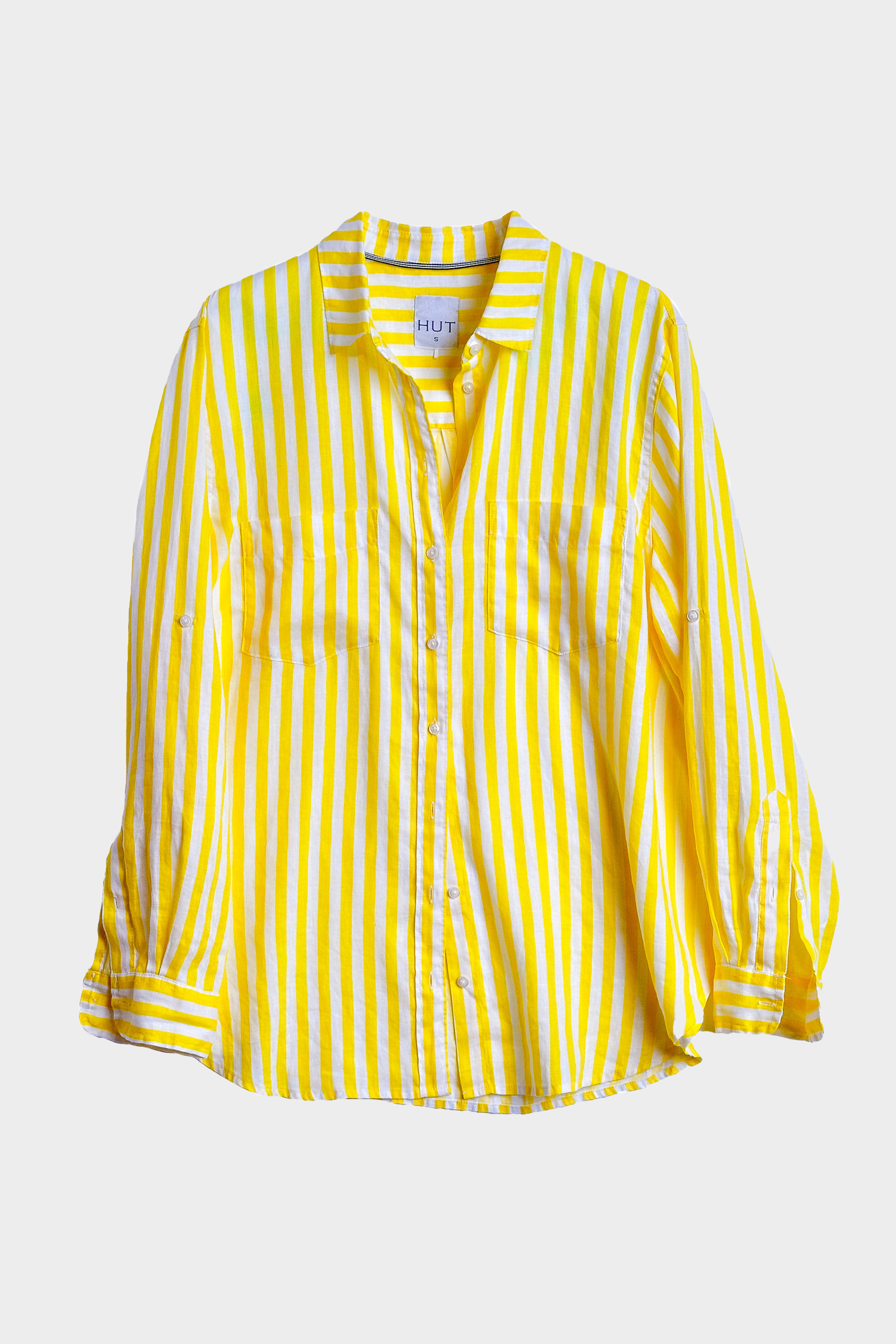 Yellow and white striped linen boyfriend shirt with two pockets and tab sleeves on a light gray background