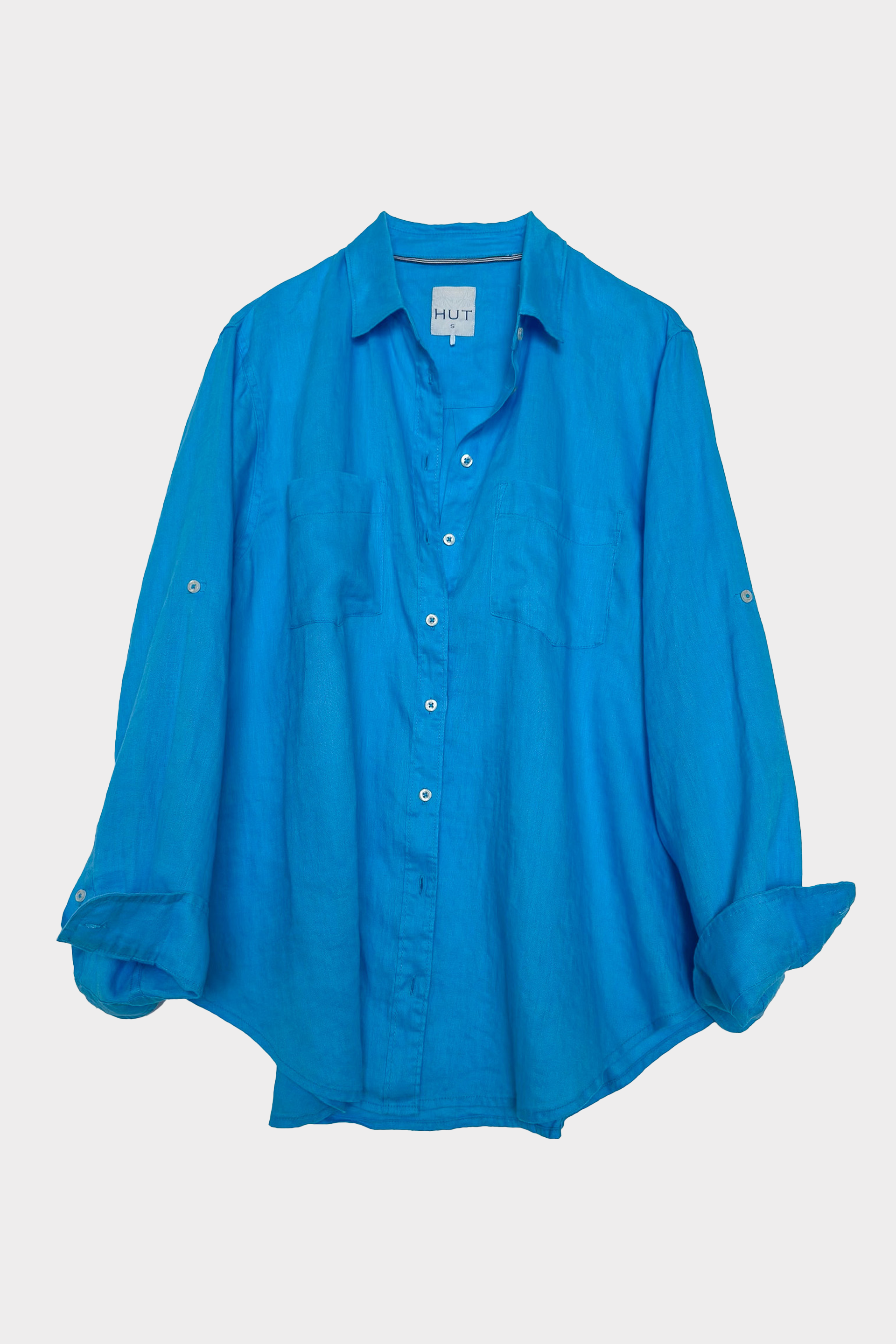 Blue linen boyfriend shirt with two chest pockets on a white background