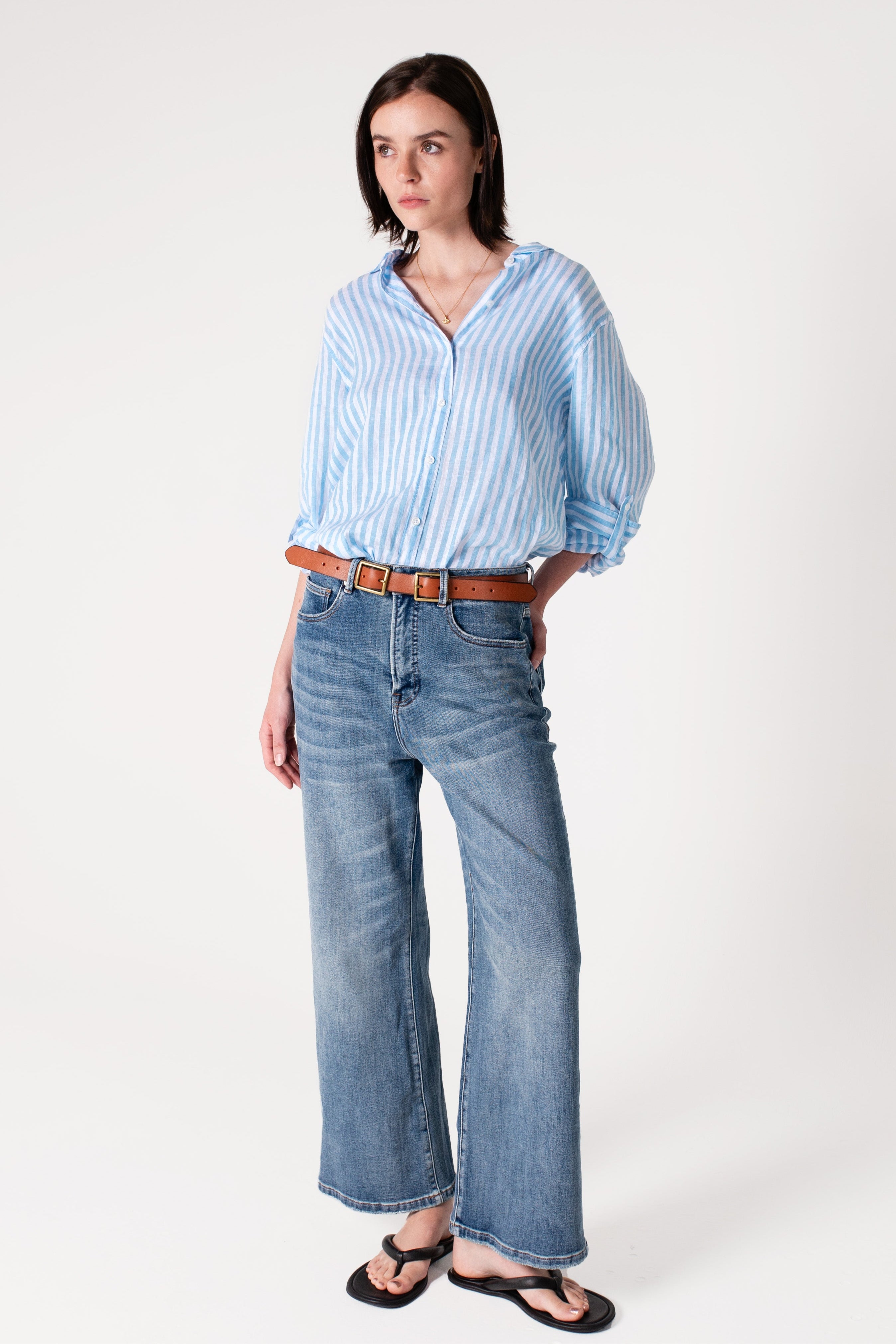 Model wearing Hut Sky Blue Stripe Boyfriend Linen Shirt with denim jeans and sandals