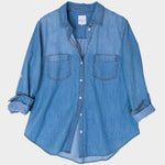 HUT Blue denim oversized shirt on a light gray background