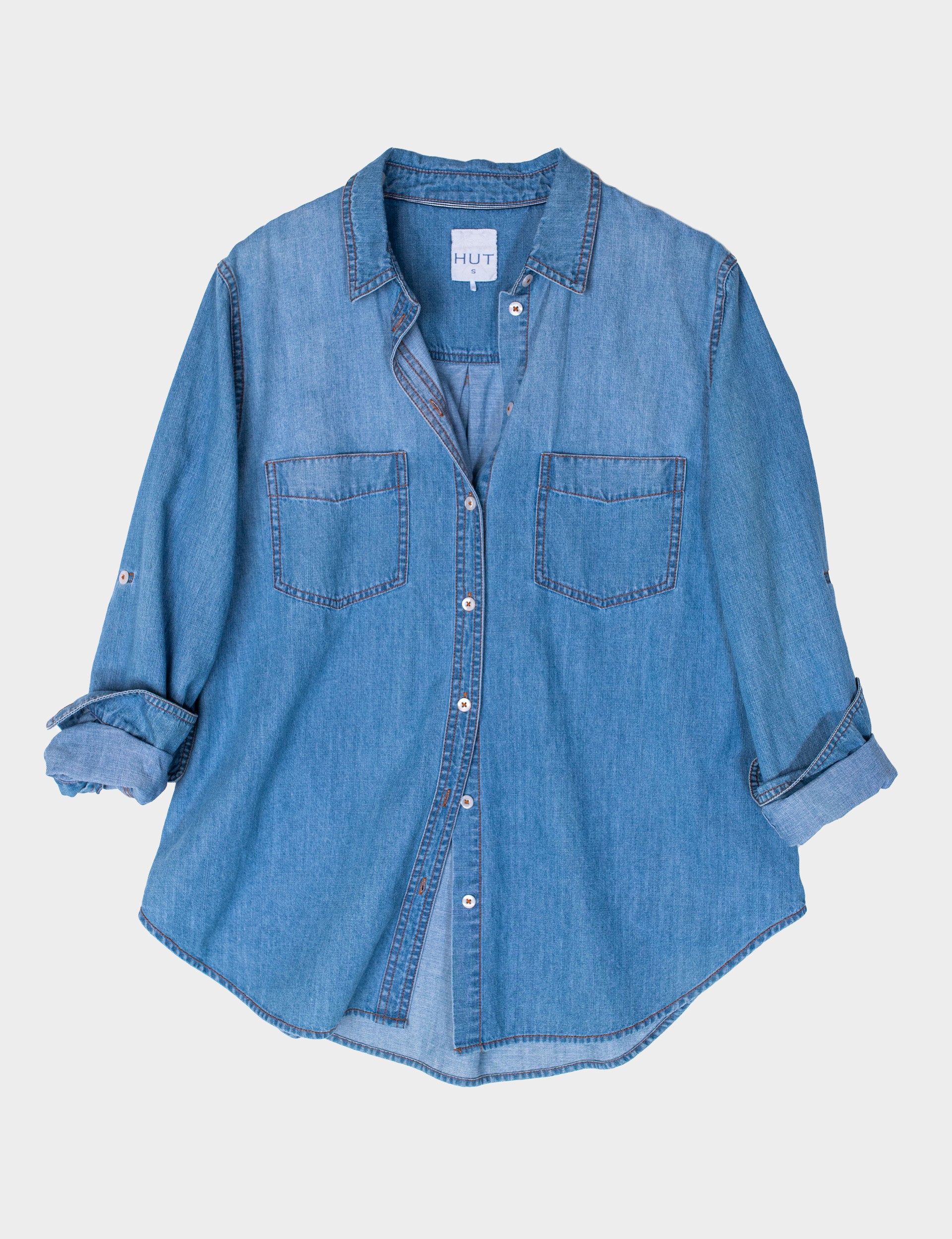 HUT Blue denim oversized shirt on a light gray background