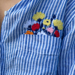 Close up of Flowers In My Pocket blue stripe and floral embroidery boyfriend linen shirt