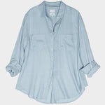 Light blue button-up linen boyfriend shirt with tab sleeves and two chest pockets on a white background