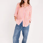 Model wearing Hut clothing groove stripe boyfriend linen shirt and denim jeans against a white background