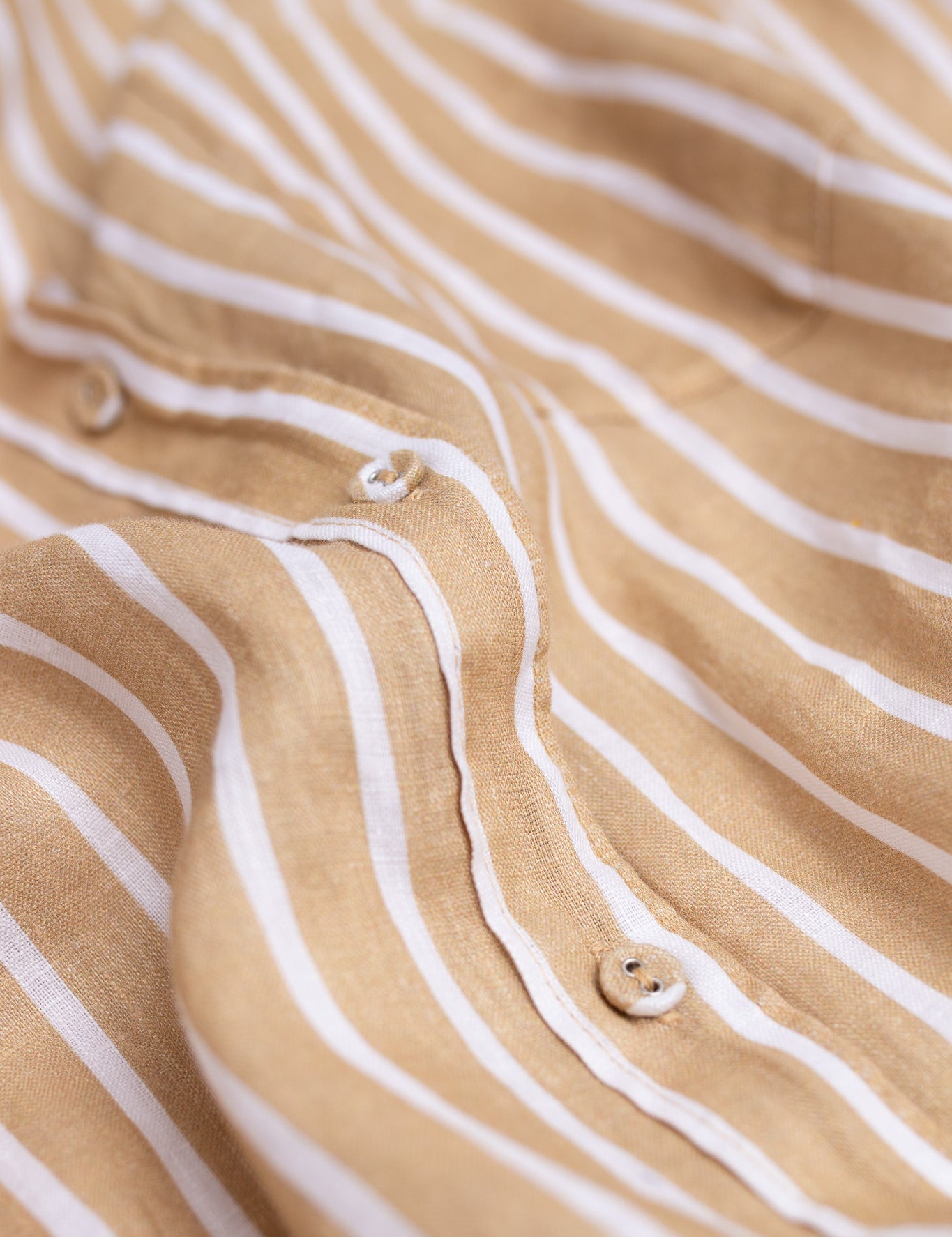 Close up of placket, self covered buttons and fabric