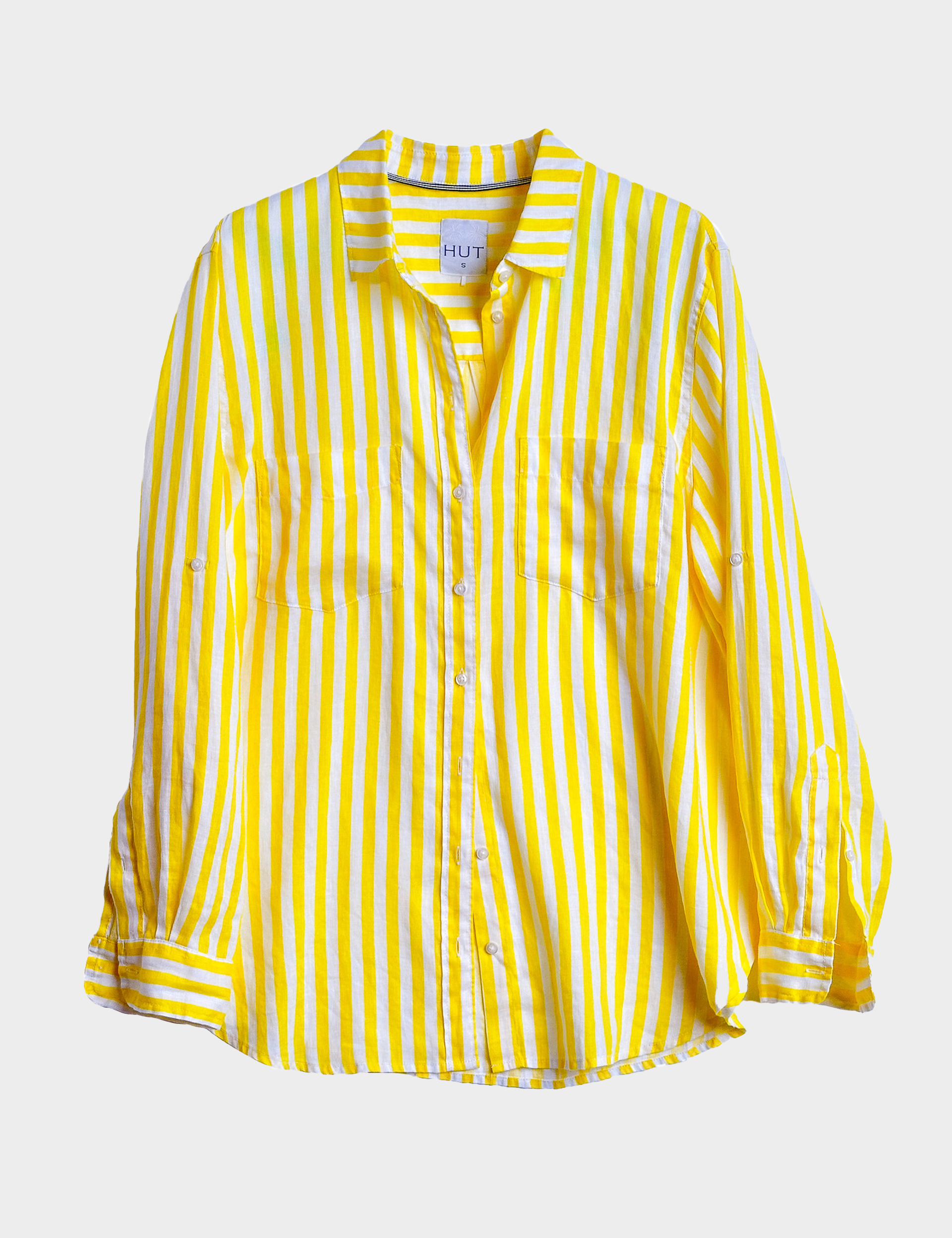 Yellow and white striped linen boyfriend shirt with two pockets and tab sleeves on a light gray background