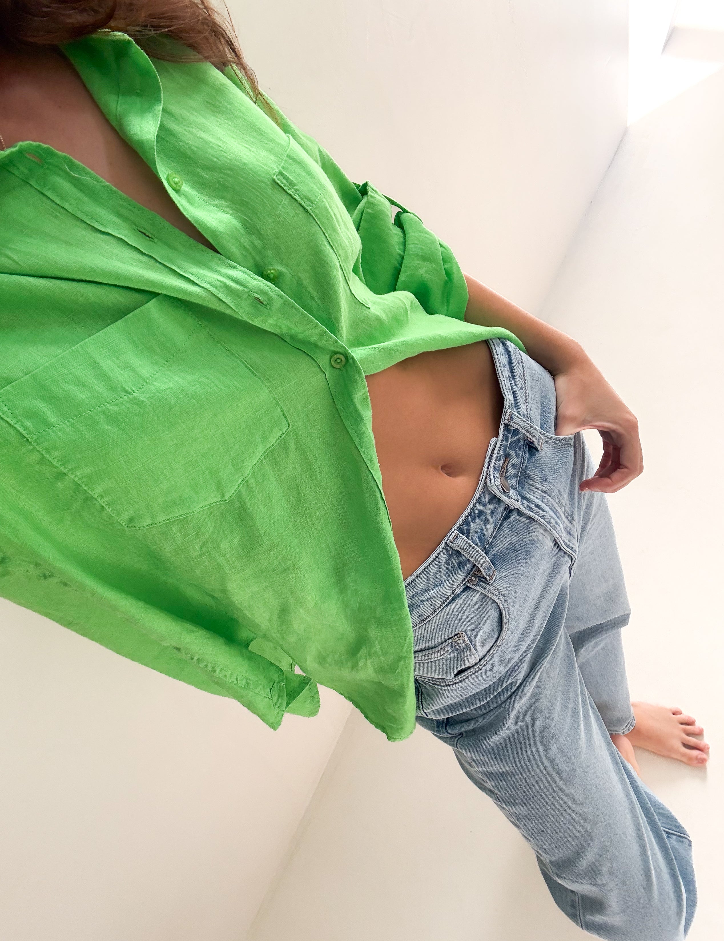 green hut Boyfriend Linen shirt and blue jeans on a white background