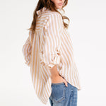 Model wearing Hut Honeycomb Stripe Boyfriend Linen Shirt with hand in back pocket of denim jeans